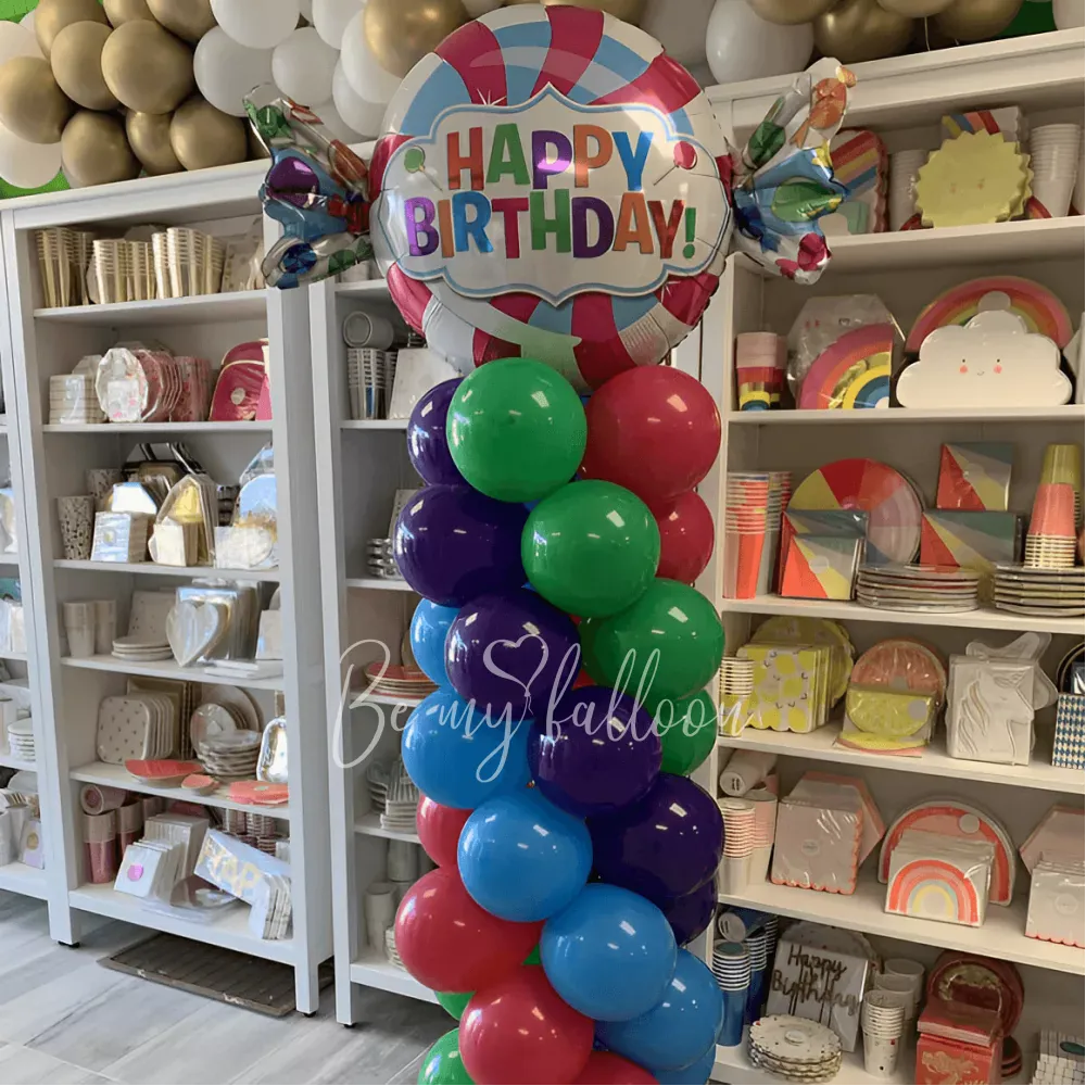 Multicolour pillar with a Candy Happy Birthday balloon composition